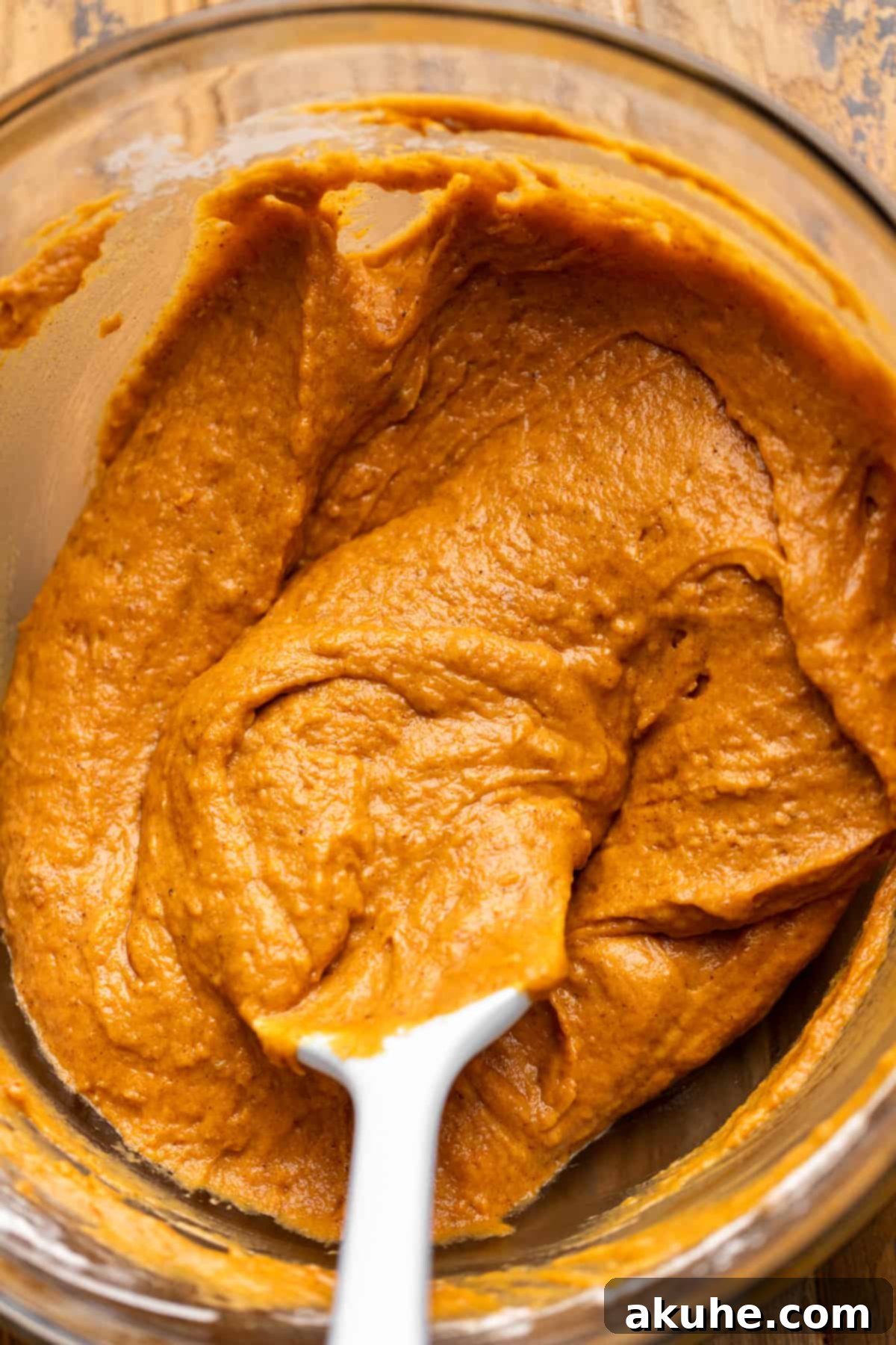 Autumn Pumpkin Spice Cupcakes 5 Close-up of the fully combined pumpkin cupcake batter in a glass bowl, ready for baking.