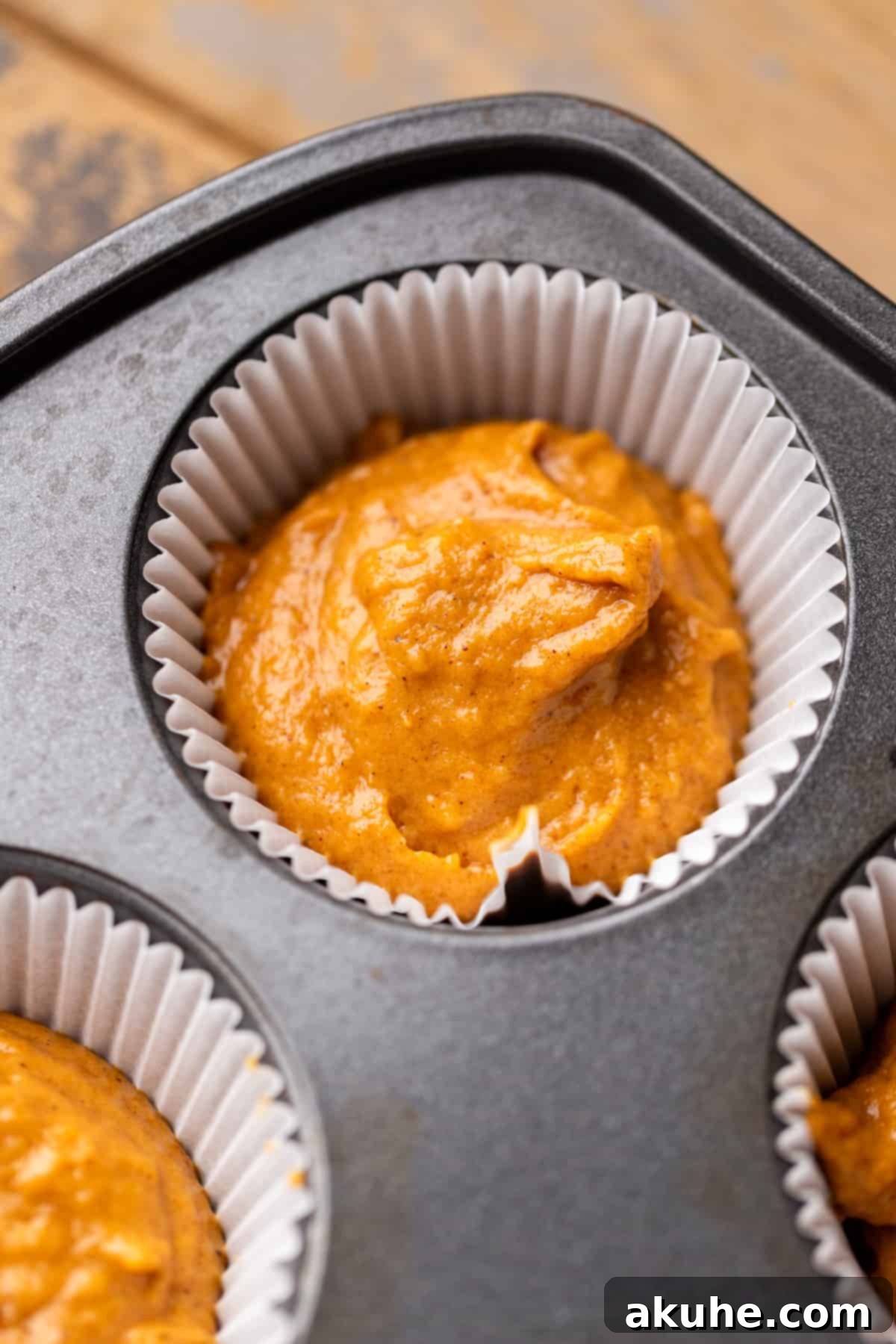 Autumn Pumpkin Spice Cupcakes 6 Pumpkin cupcake batter evenly scooped into a muffin pan, ready for baking.