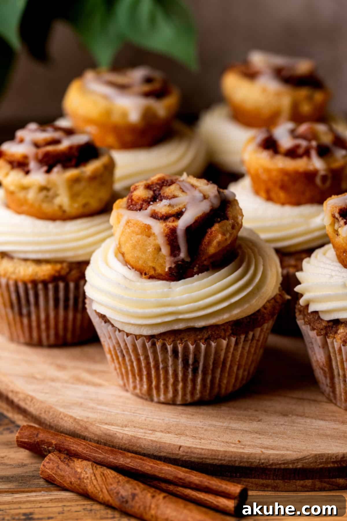 Irresistible Cinnamon Roll Cupcakes displayed on a rustic wood board, showcasing their golden-brown tops and creamy frosting.