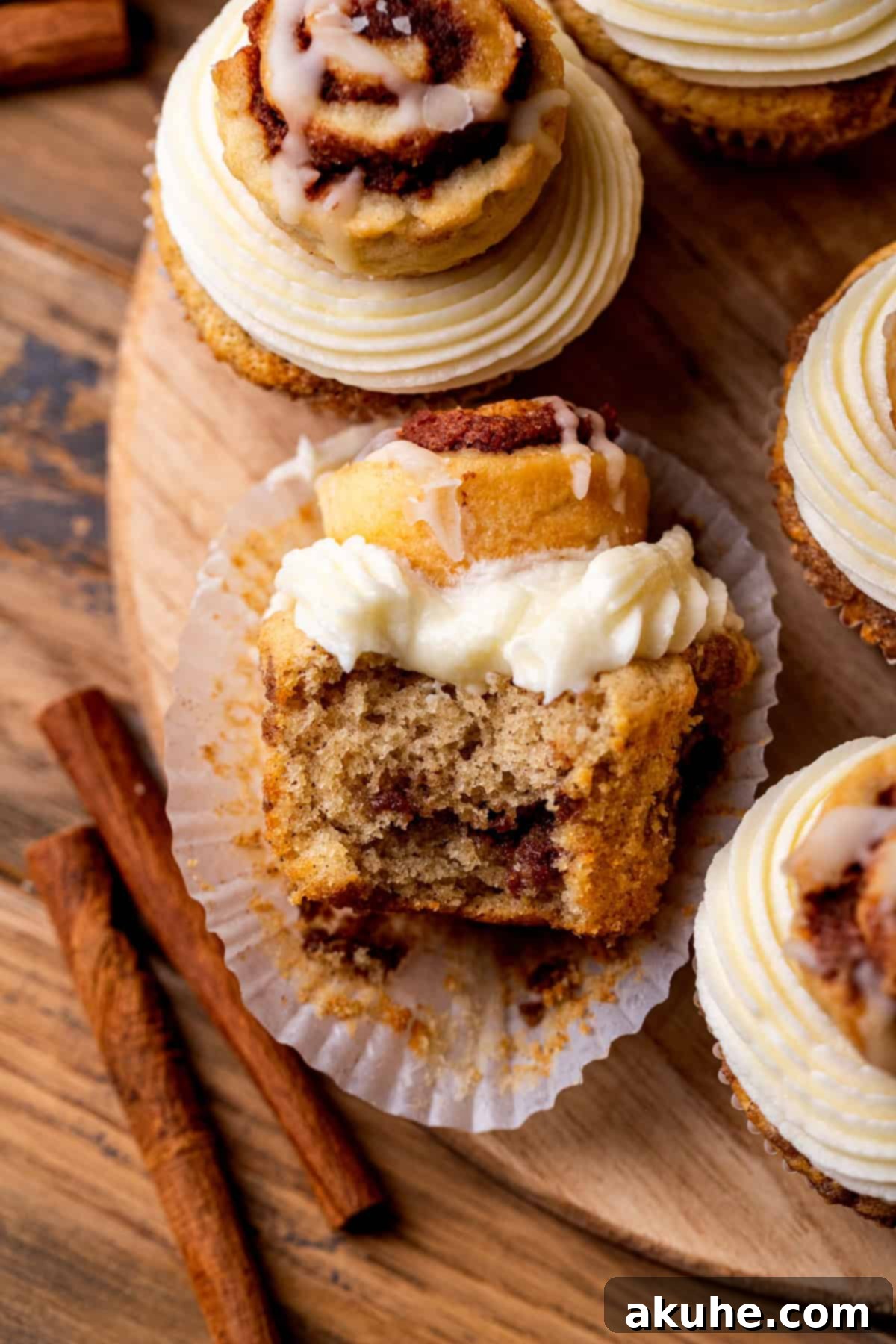 Another top-down view of a Cinnamon Roll Cupcake with a bite taken out, showing the intricate layers and inviting texture.