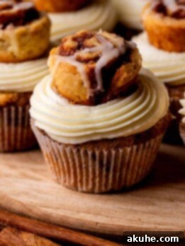 Cinnamon roll cupcakes on a wood board.