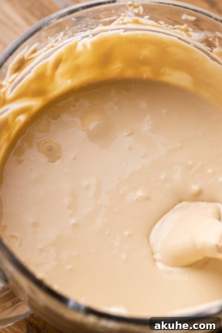 Pecan Pie Cheesecake 5 Creamy cheesecake batter in a mixing bowl.