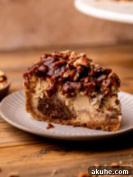 Pecan Pie Cheesecake 10 One slice of pecan pie cheesecake on a plate.
