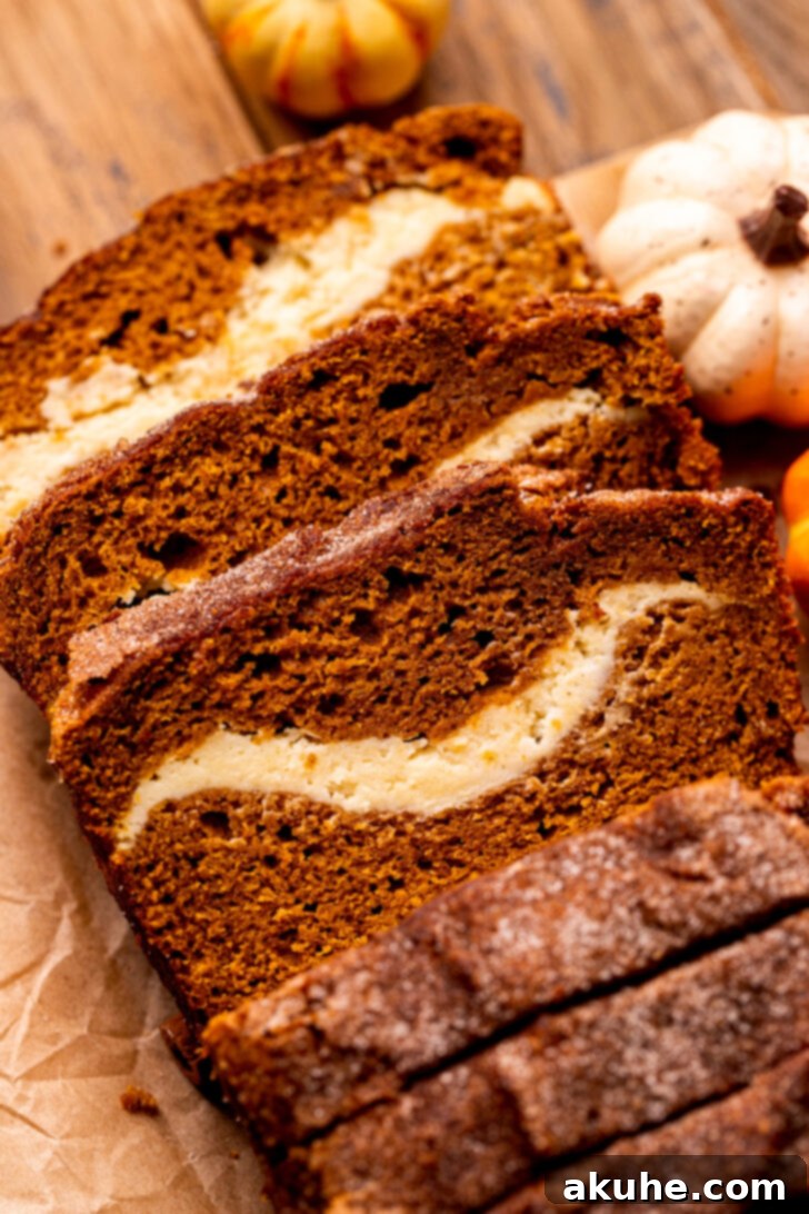 Cream Cheese Swirled Pumpkin Bread 2 Top view of pumpkin cream cheese bread sliced up, showcasing the beautiful swirl.