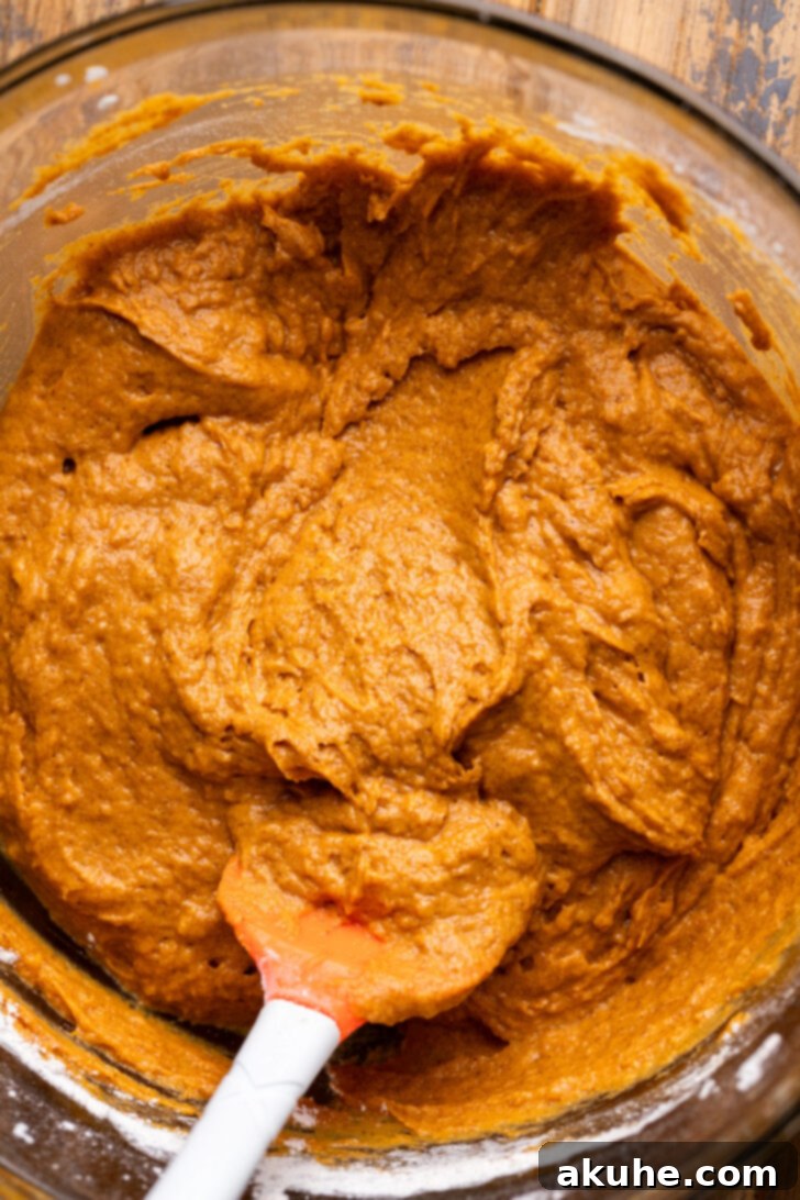 Cream Cheese Swirled Pumpkin Bread 5 Thick and rich pumpkin batter in a glass bowl, ready for baking.