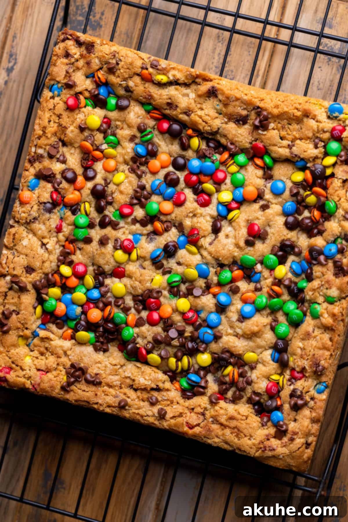 Ultimate Monster Cookie Bars 6 Warm, golden-brown monster cookie bars cooling on a wire rack after being freshly baked.