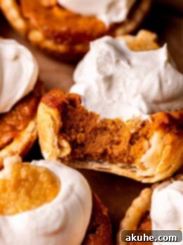 Top view of a bite missing from mini pumpkin pies.