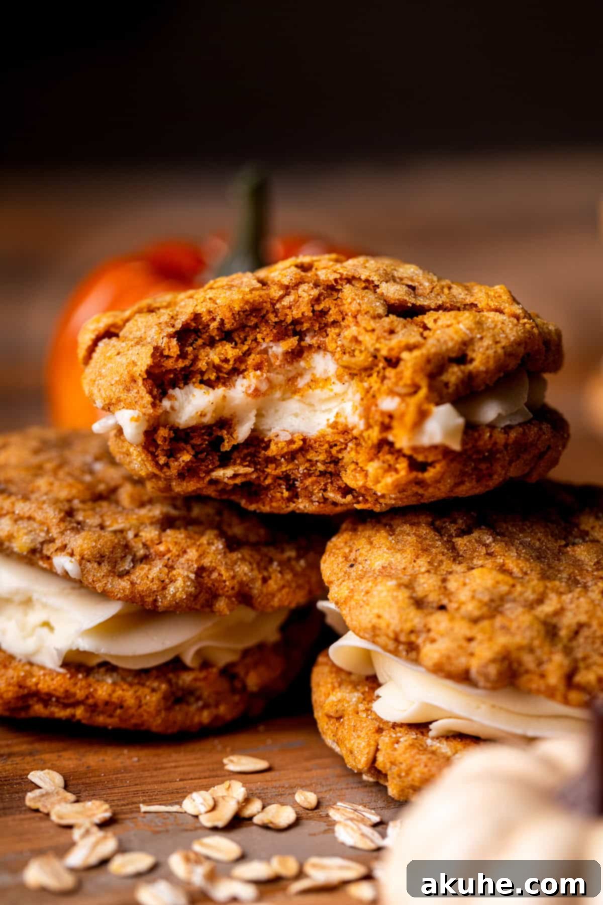 Spiced Pumpkin Oatmeal Cream Pies 2 A stack of three homemade pumpkin oatmeal cream pies, showcasing their inviting texture and generous filling.