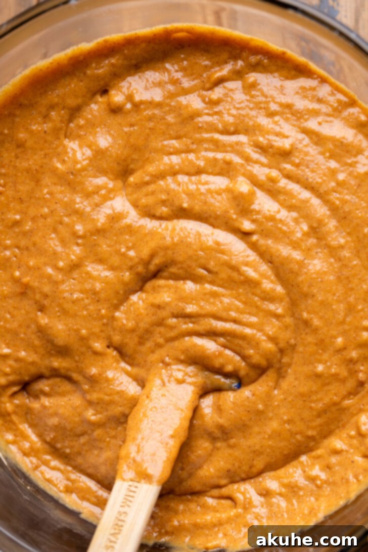 Spiced Pumpkin Caramel Cake 4 Pumpkin cake batter in a bowl, ready to be poured into pans.