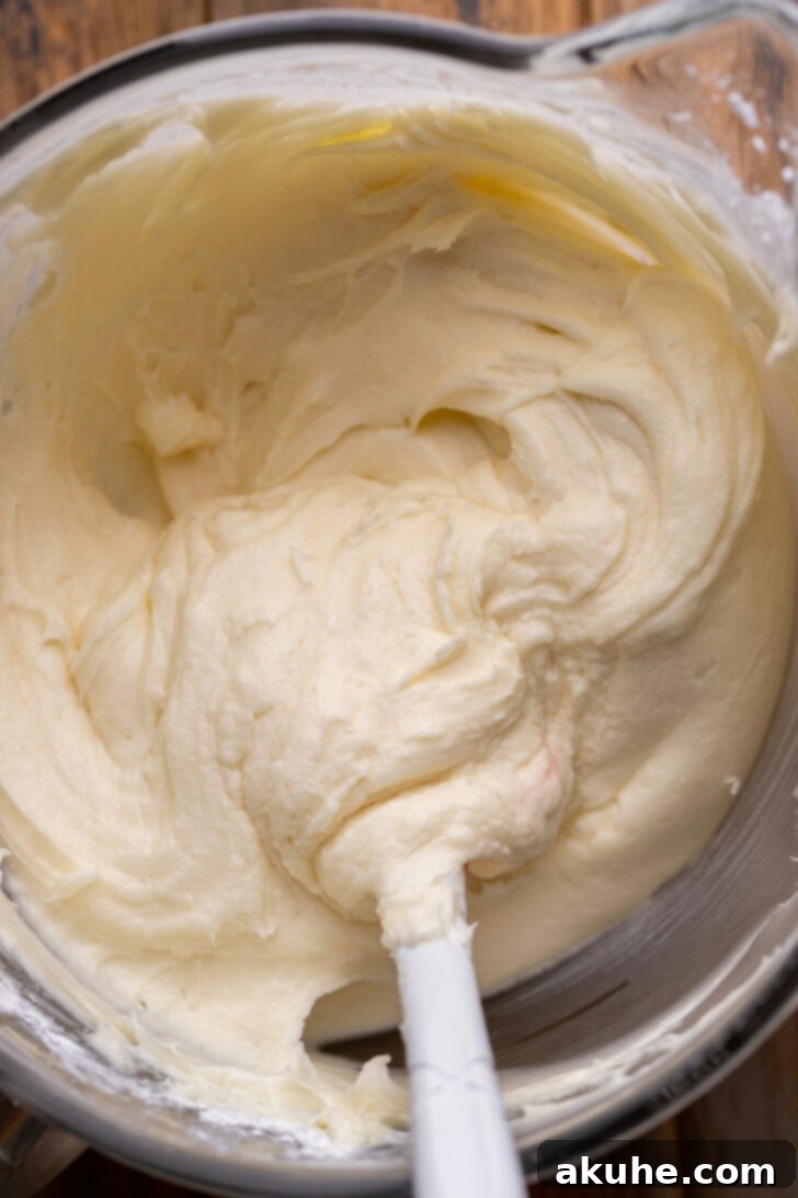 Spiced Pumpkin Caramel Cake 6 Cream cheese frosting in a bowl, fluffy and ready to use.