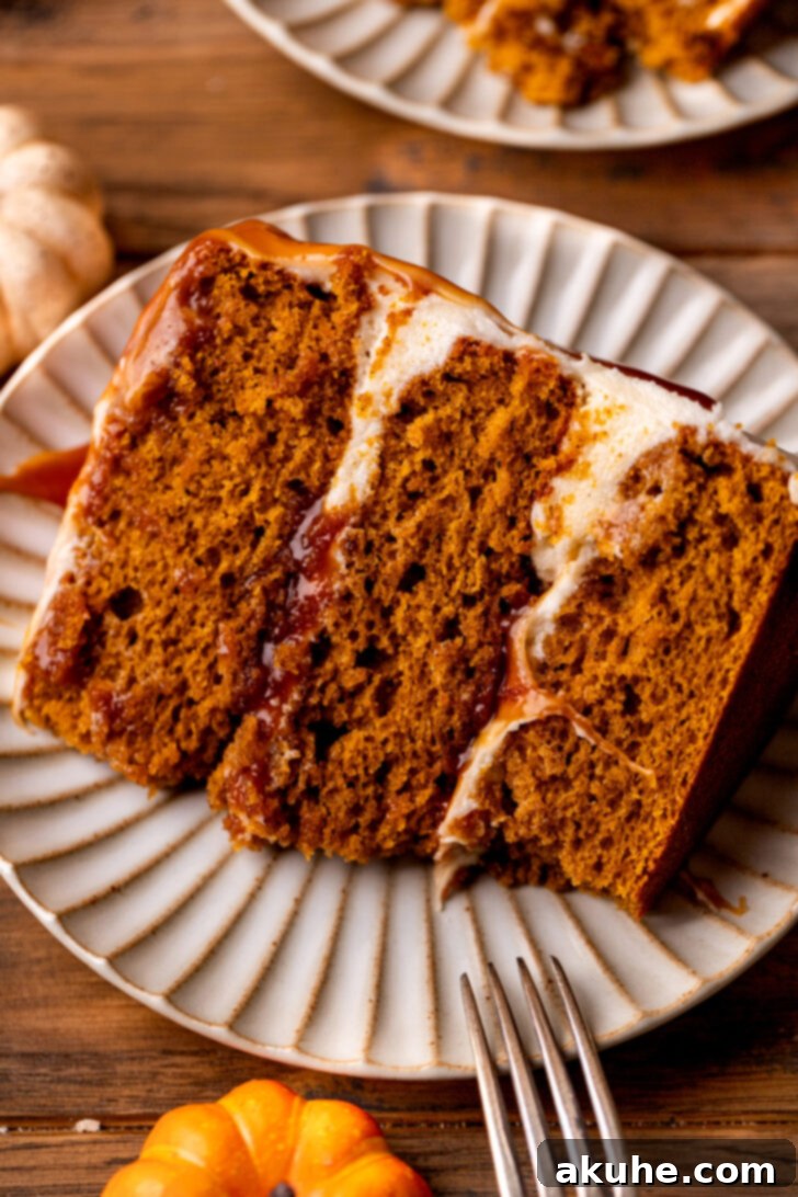 Spiced Pumpkin Caramel Cake 8 A perfect slice of pumpkin caramel cake on a white plate, showcasing all the beautiful layers.