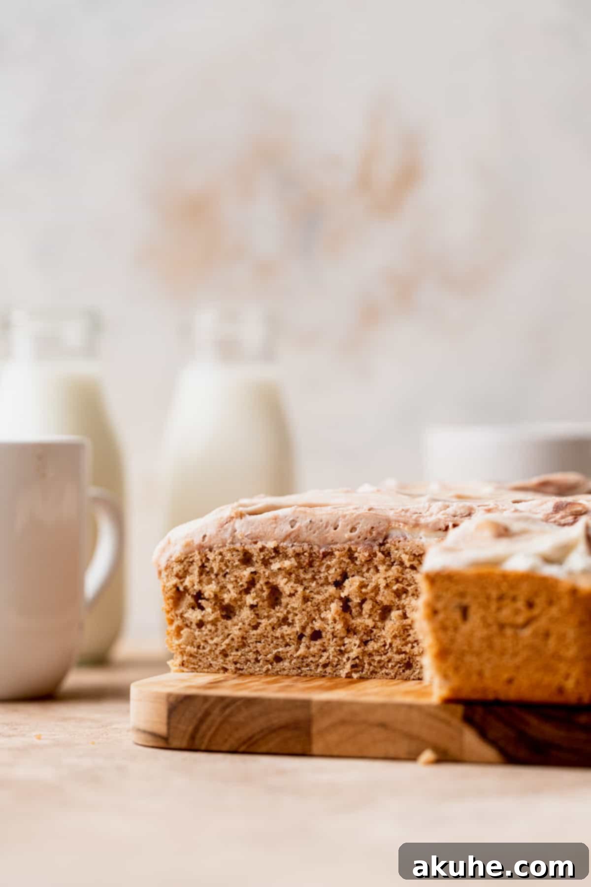 A beautiful side view of the Chai Spiced Sheet Cake, highlighting the impressive height and perfect frosting swirls.