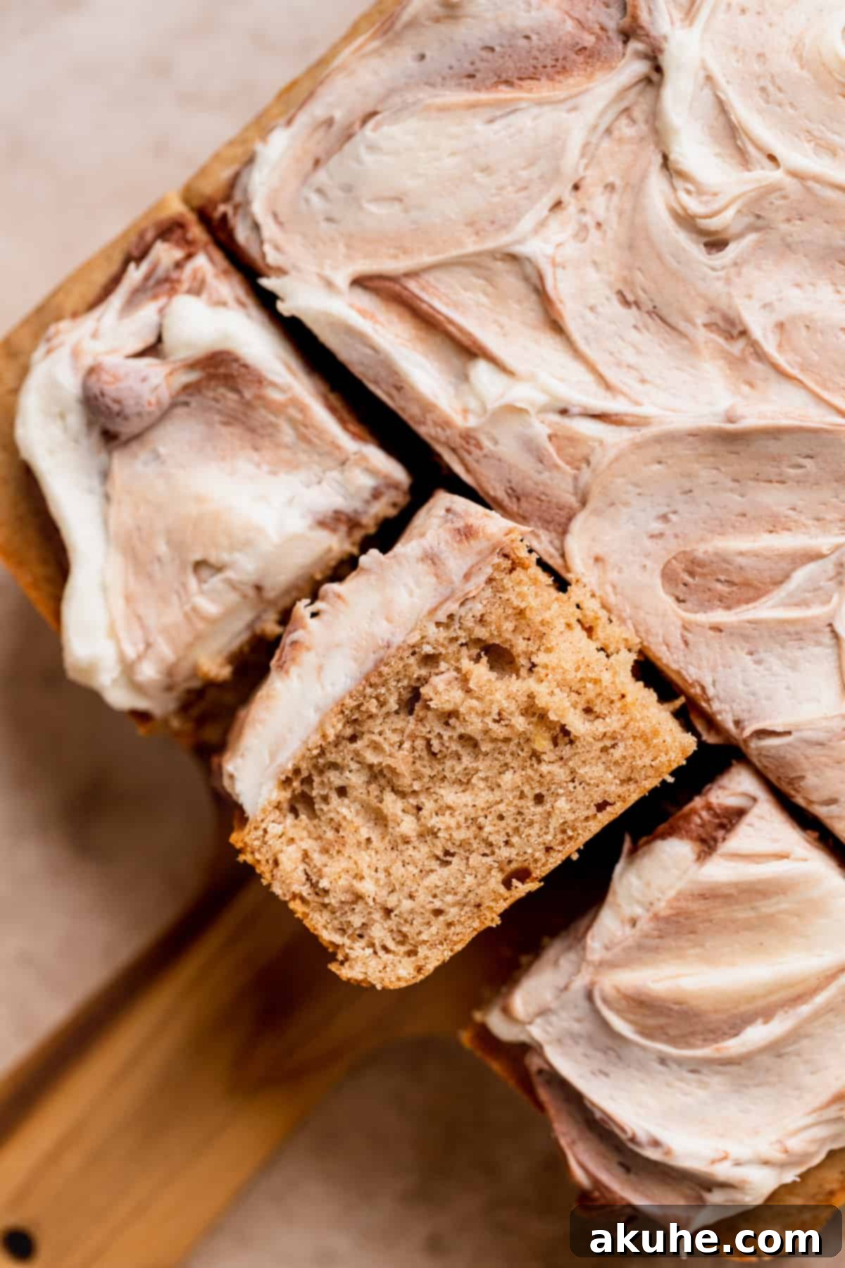 A delicious slice of Chai Spiced Sheet Cake presented on its side, revealing the moist cake layers and luscious frosting.