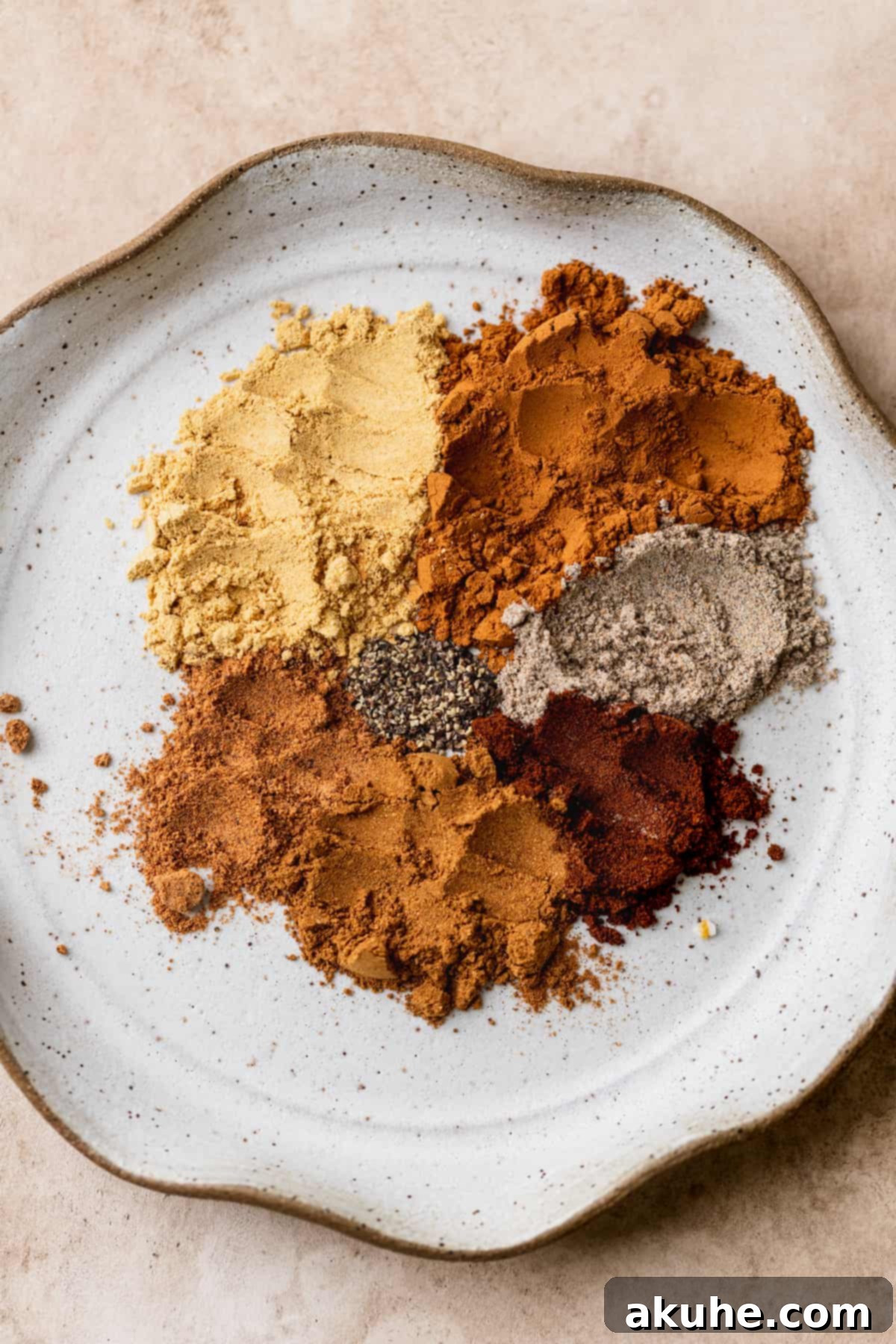 An array of chai spices artfully arranged on a plate, ready to infuse the cake with warmth.