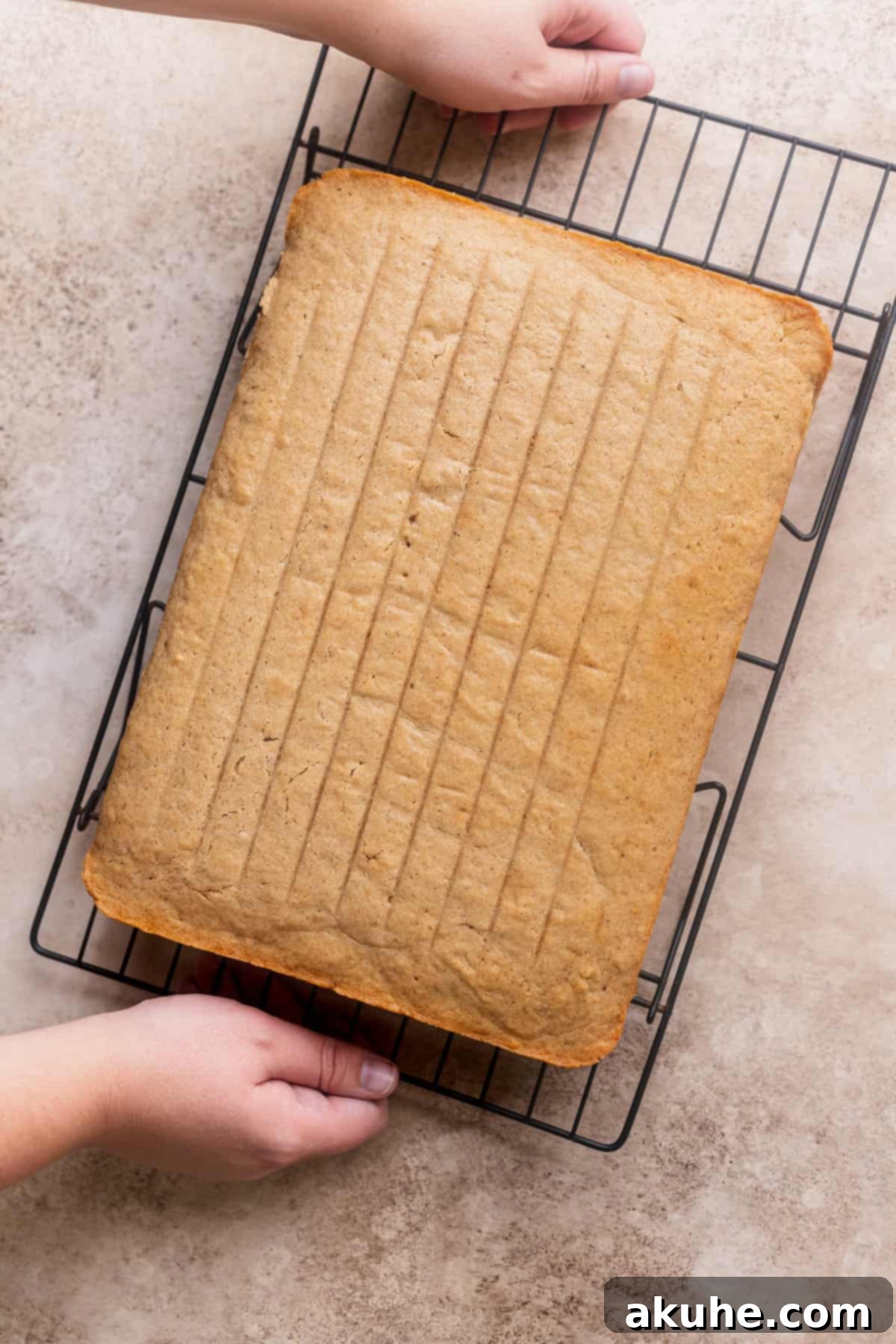 A freshly baked Chai Spiced Sheet Cake cooling on a wire rack, awaiting its luxurious frosting.