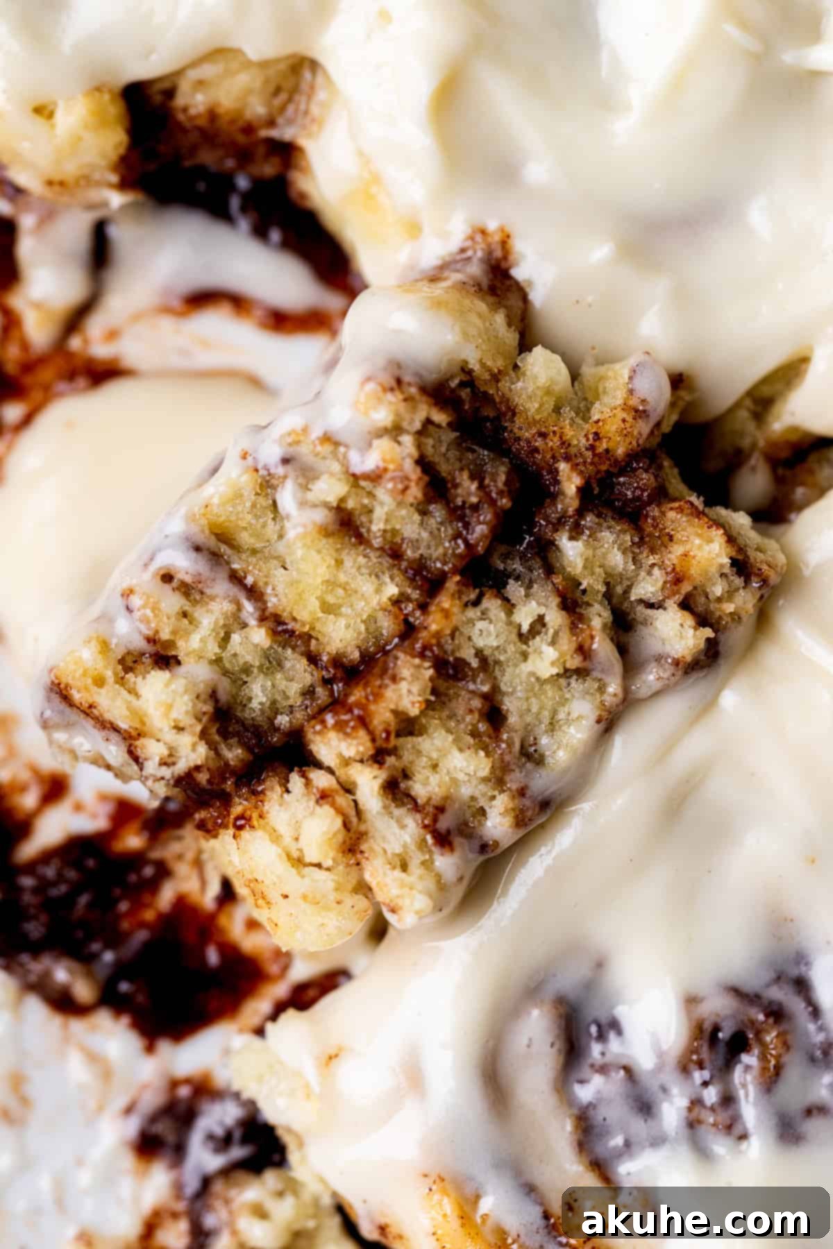 A single no yeast cinnamon roll cut in half, revealing the soft interior and cinnamon swirl.