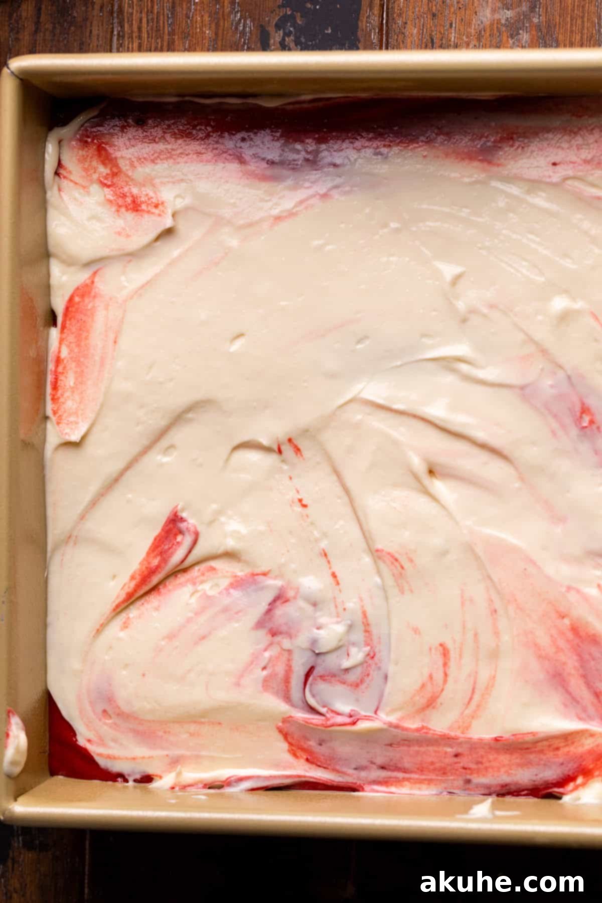 Festive Red Velvet Cake 6 The smooth cream cheese layer evenly spread in the baking pan, forming the heart of the cake.