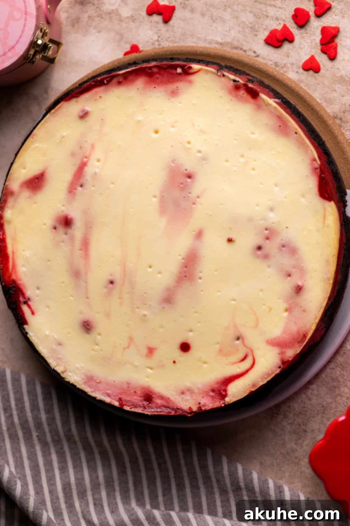Red Velvet Decadence 9 A freshly baked cheesecake, golden brown and perfectly set, on a cooling board.
