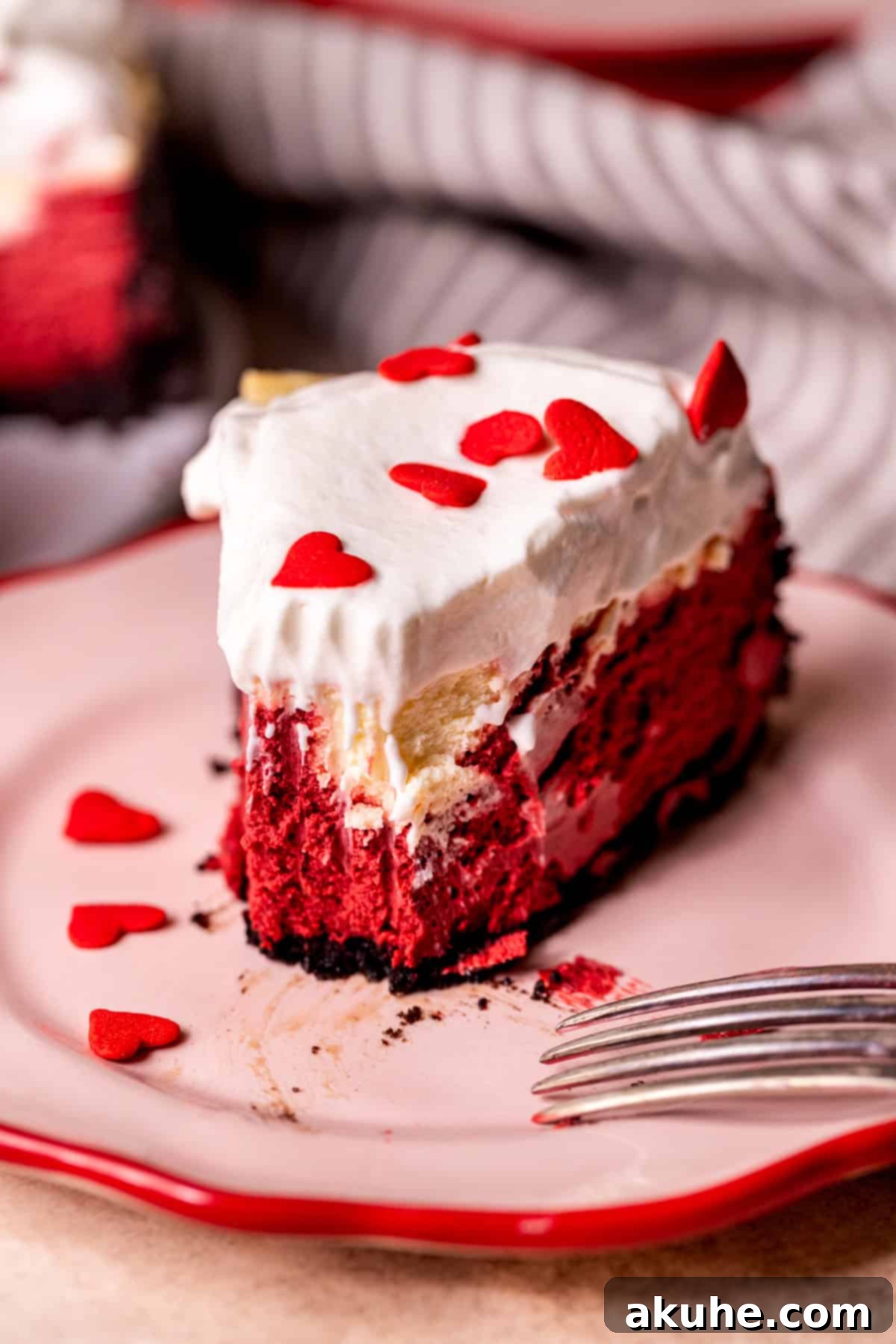 Red Velvet Decadence 10 A slice of red velvet cheesecake with a bite taken out, showing the texture.