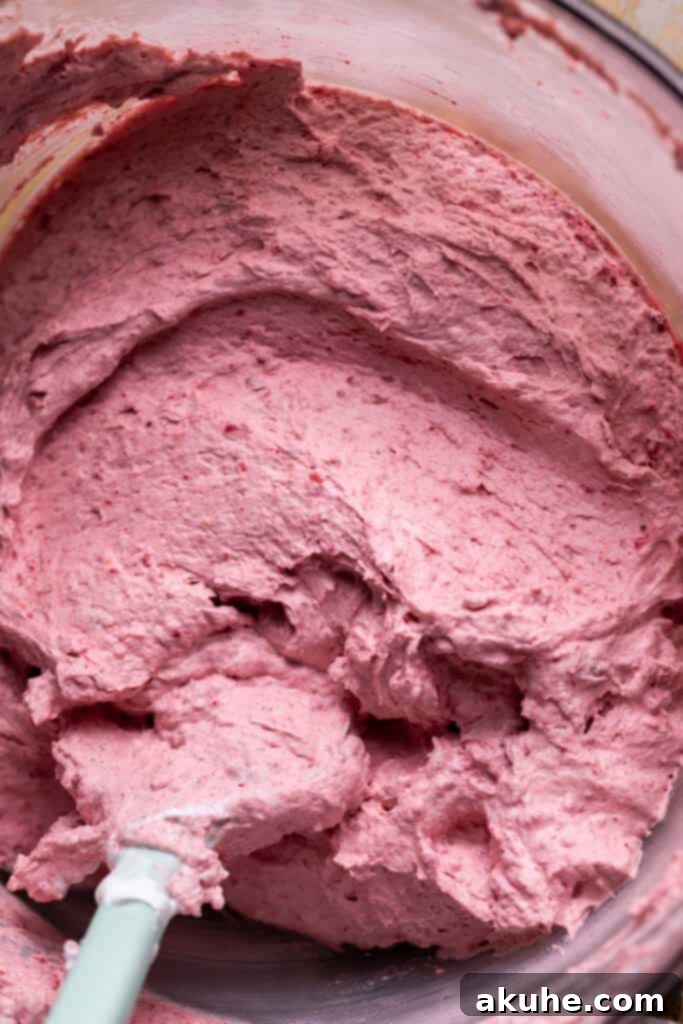 Raspberry Chocolate Cloud Cake 7 Raspberry mousse in a glass bowl after folding in whipped cream.