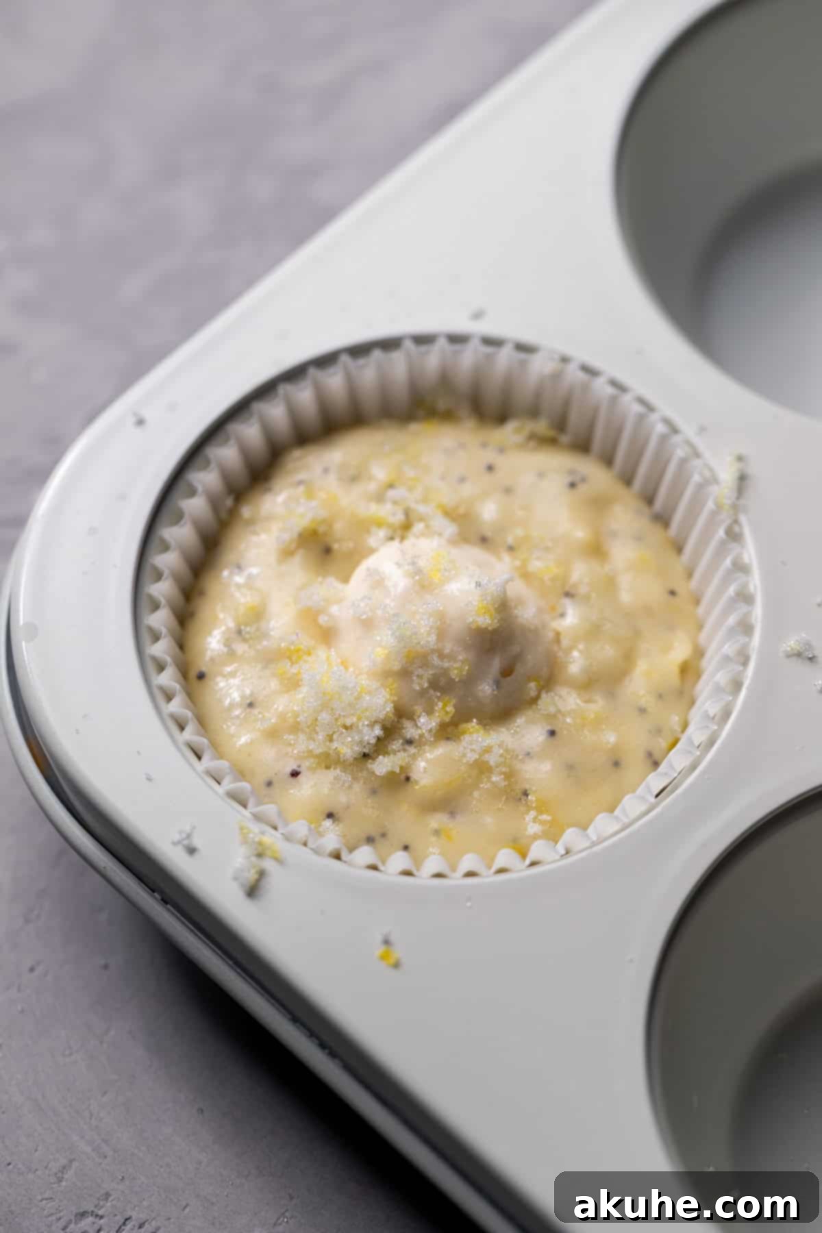 Zesty Cream Cheese Muffin Perfection 8 Cream cheese dollop on top of muffin batter.