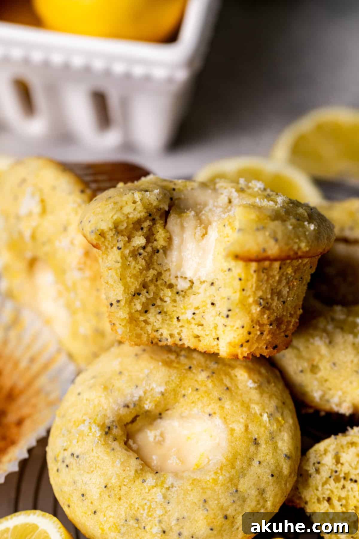 Zesty Cream Cheese Muffin Perfection 9 Bite missing from muffin on top of another muffin.