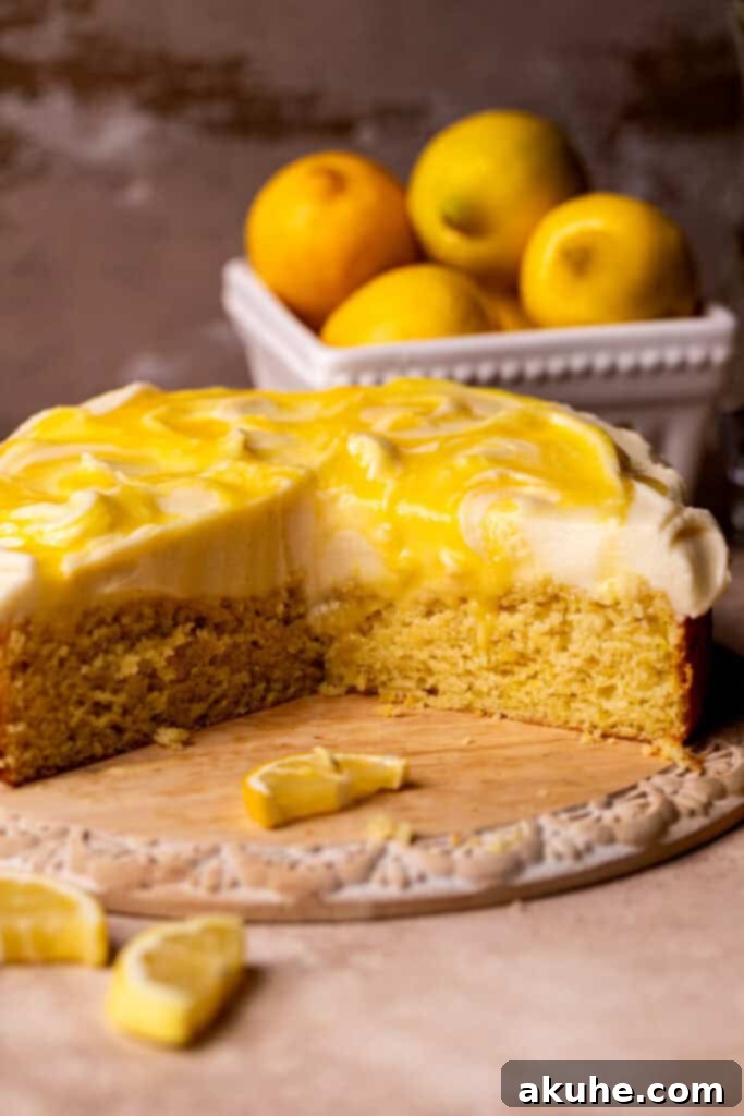 Side view of a beautifully decorated lemon curd cake with cream cheese frosting and swirled lemon curd.