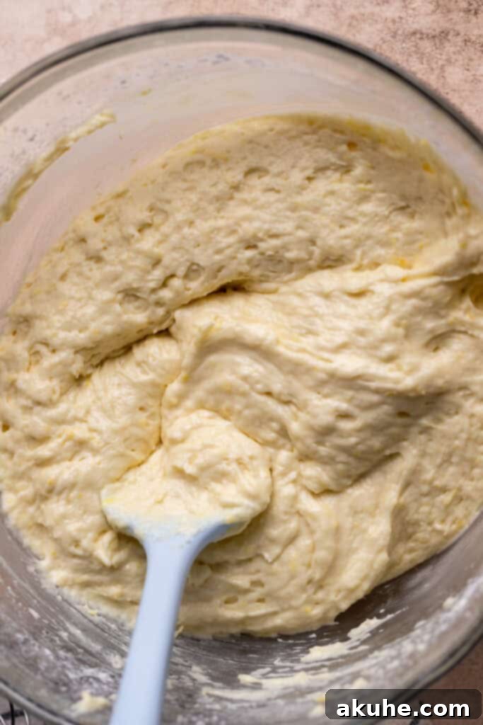 Lemon cake batter in a glass bowl after dry ingredients are added.