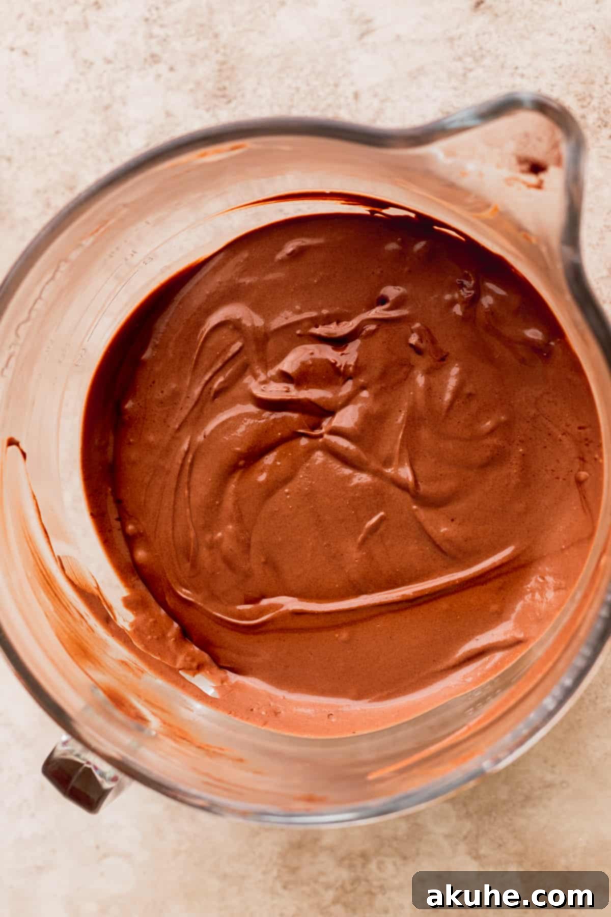 Decadent Triple Chocolate Cheesecake 5 Smooth, dark chocolate cheesecake batter in a large glass bowl.