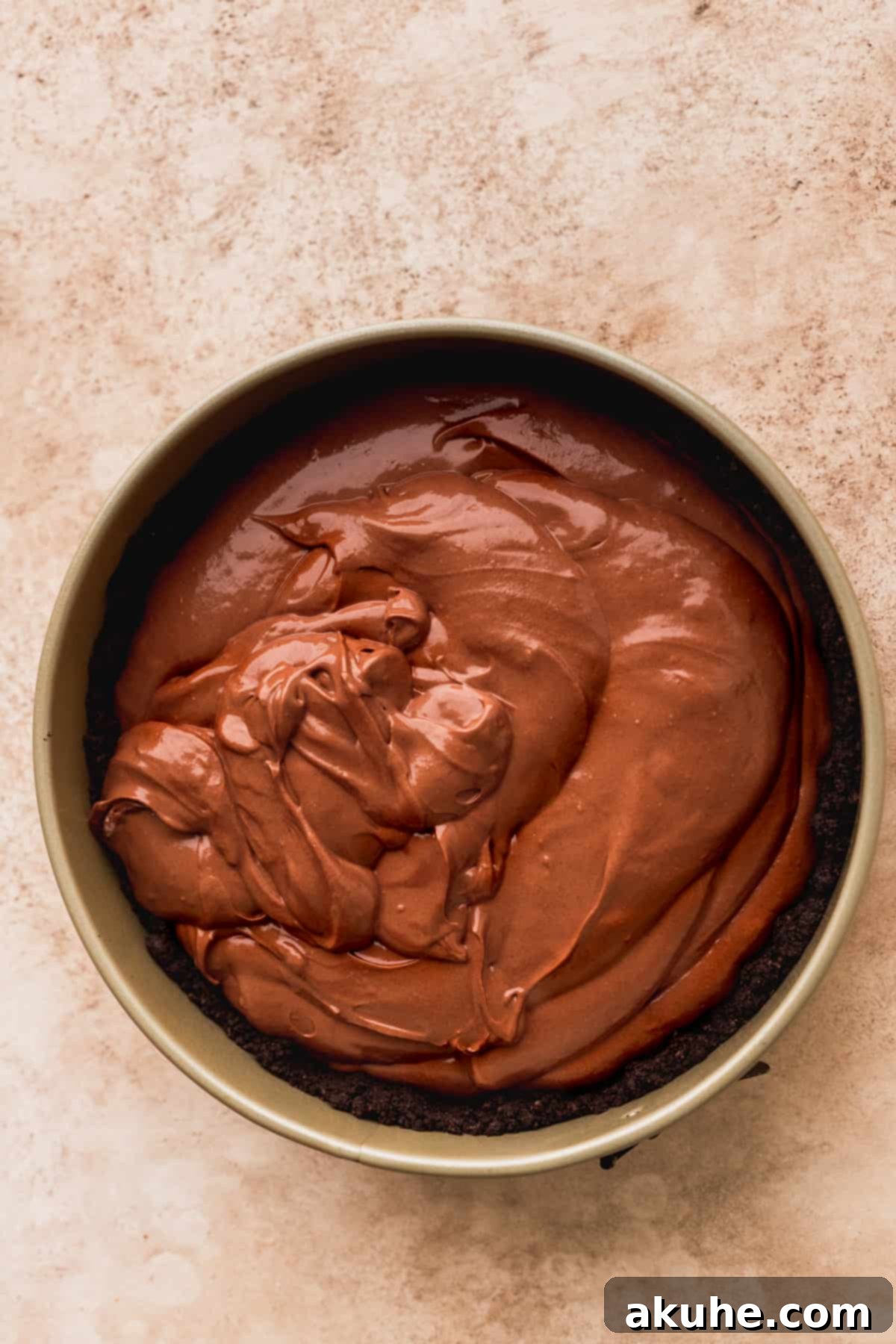 Decadent Triple Chocolate Cheesecake 6 Chocolate cheesecake batter poured into an Oreo crust in a springform pan.