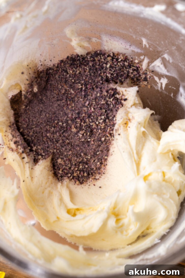 Velvety Blueberry Buttercream 5 Frosting with grounded freeze dried blueberries on top, ready to be mixed.