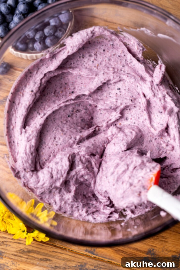 Velvety Blueberry Buttercream 6 A bowl of creamy, light purple blueberry frosting, perfectly smooth.