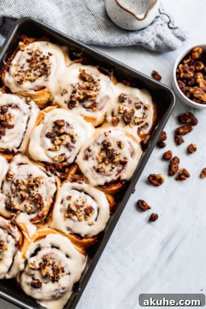 Nutty Cinnamon Swirls 2 Walnut cinnamon rolls with sweet maple nuts on top, beautifully arranged.