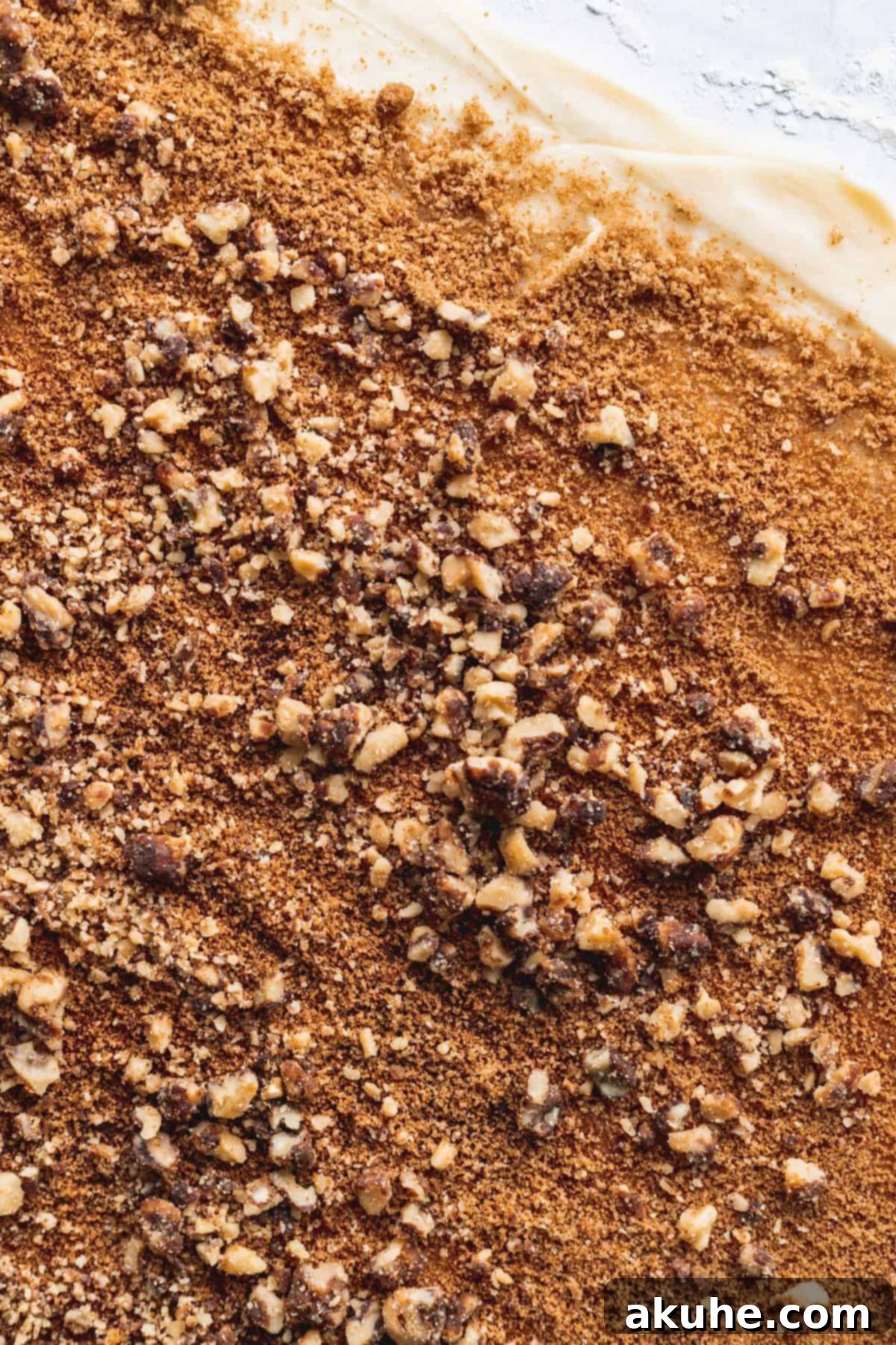 Nutty Cinnamon Swirls 7 Rolled out dough with cinnamon, brown sugar, and crushed maple walnuts on top.