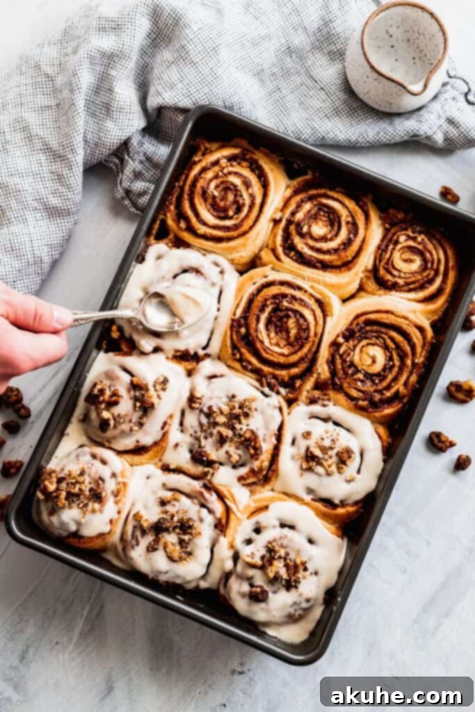 Nutty Cinnamon Swirls 10 Spreading maple cream cheese frosting on top of warm walnut cinnamon rolls.