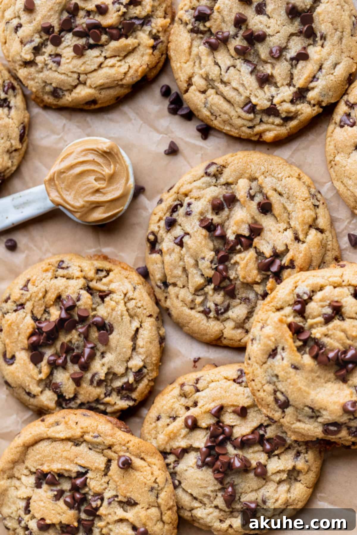 Perfect Peanut Butter Chocolate Chip Cookies 3 Peanut butter chocolate chip cookies cooling on parchment paper after baking.