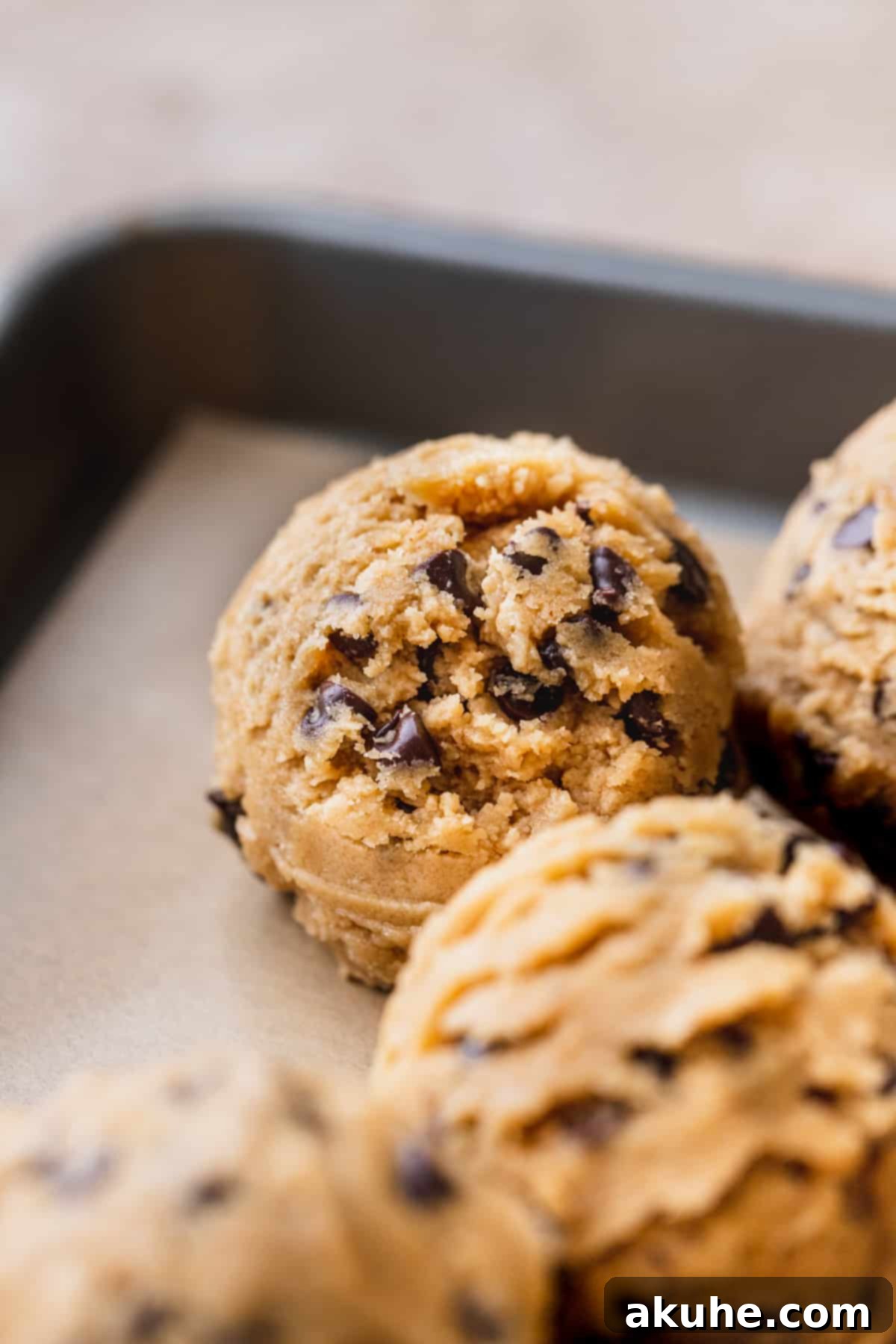Perfect Peanut Butter Chocolate Chip Cookies 7 Scooped cookie dough ball on a cookie sheet, ready to bake.