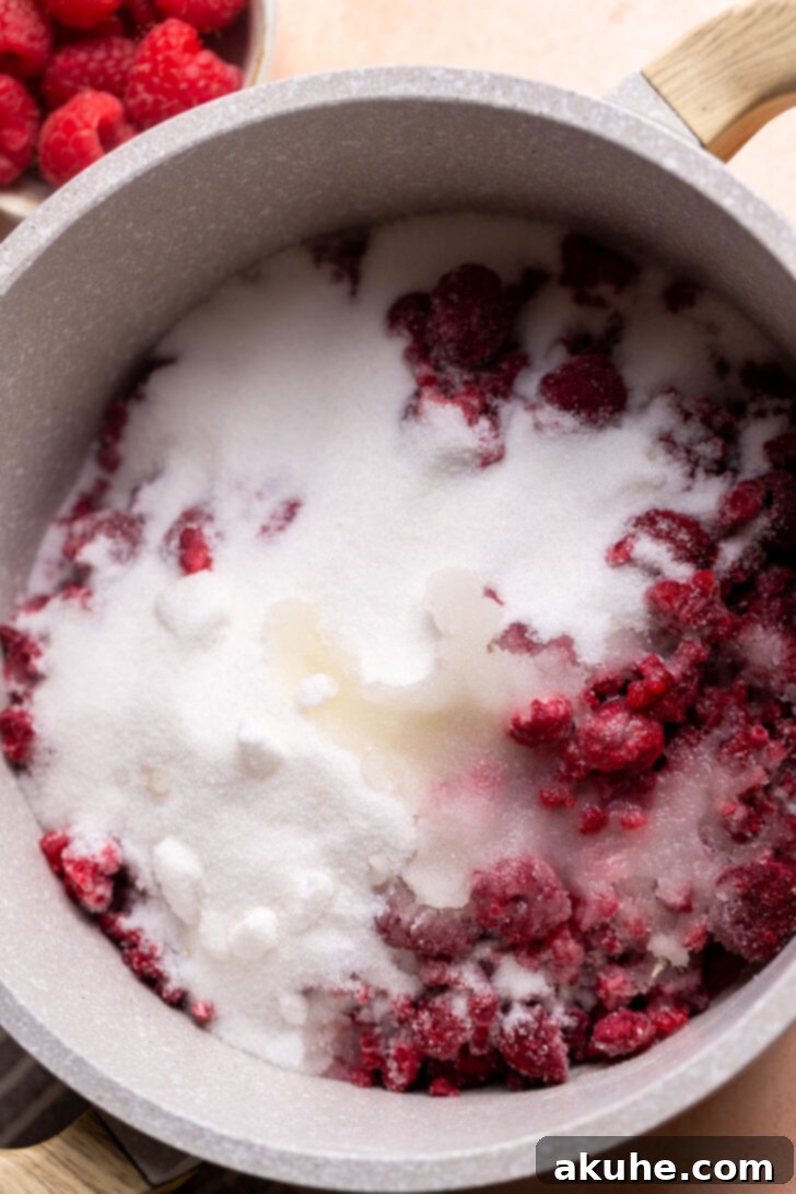 Effortless Raspberry Preserve 4 Fresh or frozen raspberries, sugar, and lemon juice ready in a pot for making jam.