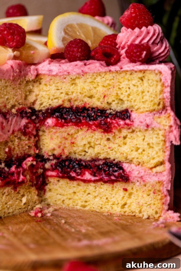 Side view of a beautifully decorated lemon raspberry cake, showcasing its elegant layers and frosting.