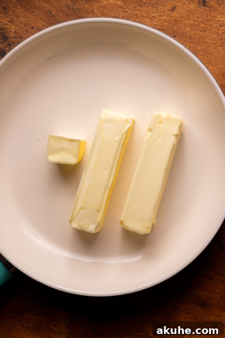 Achieving Golden Brown Butter 4 Unmelted butter cubes in a frying pan over heat.