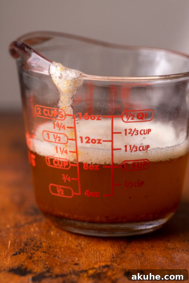Achieving Golden Brown Butter 7 Finished brown butter poured into a clear measuring cup.