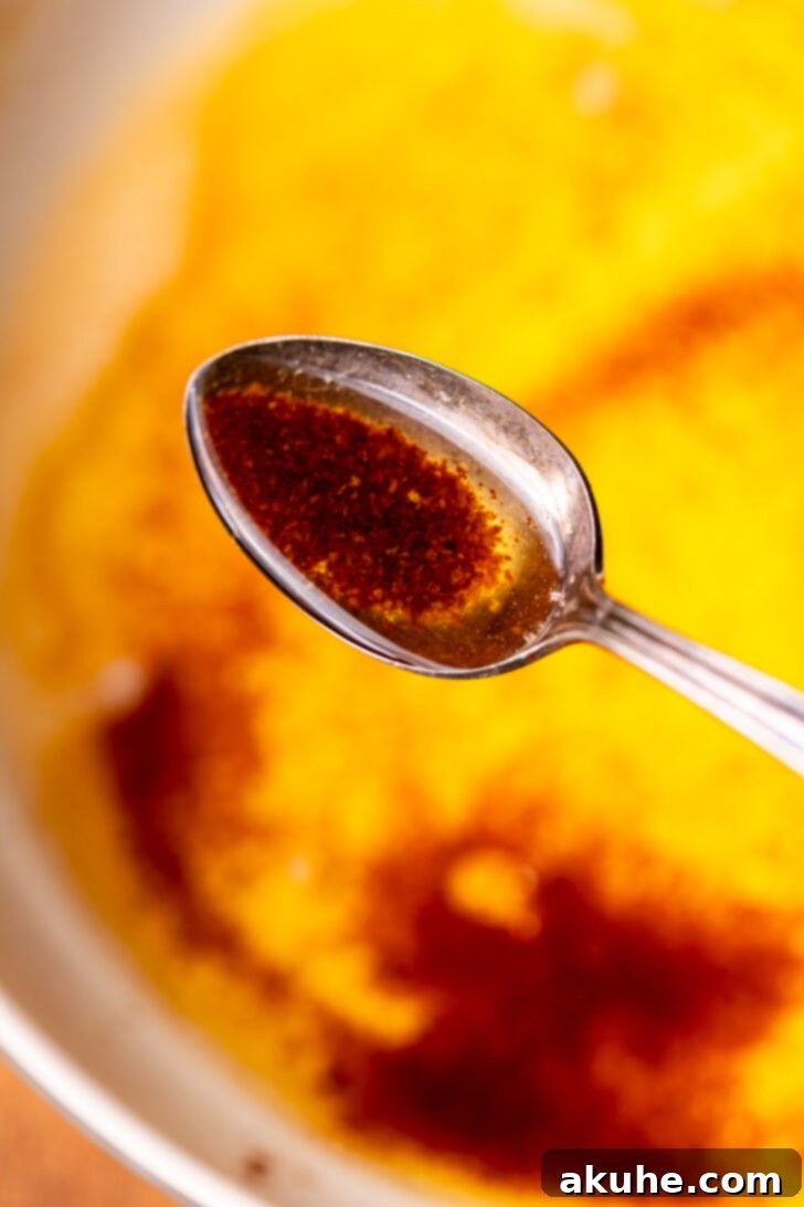 Achieving Golden Brown Butter 9 A spoonful of rich, golden brown butter, showing its texture and color.