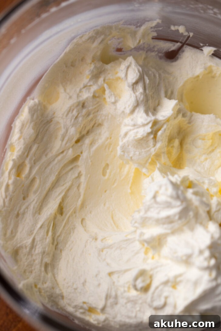 Oreo Cookie Cream 4 Softened butter and cream cheese in a mixing bowl before combining.