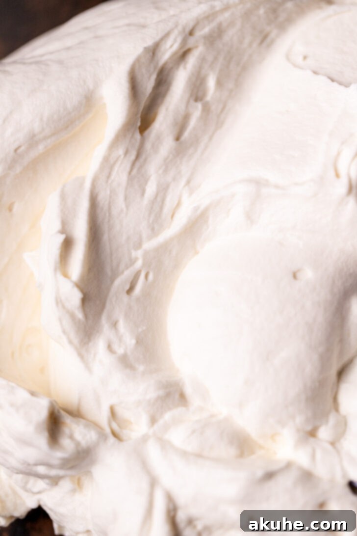 Rich Mascarpone Icing 2 Close-up view of fluffy, pristine mascarpone frosting, showcasing its smooth and inviting texture.