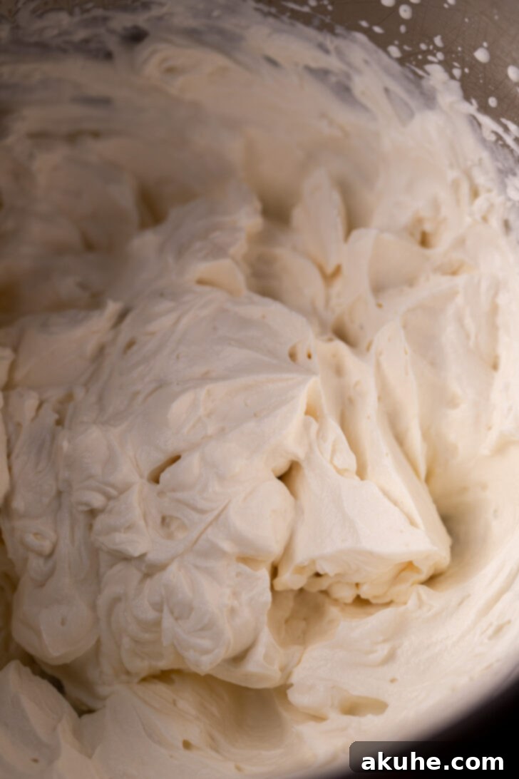 Rich Mascarpone Icing 6 Final mascarpone frosting mixture in a metal bowl, exhibiting a perfectly smooth and firm texture, ready for use.