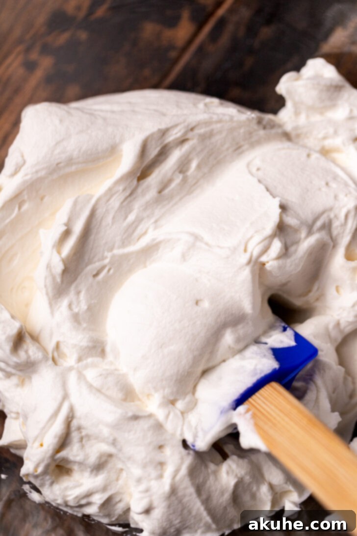 Mascarpone frosting in a bowl, resembling thick whipped cream.