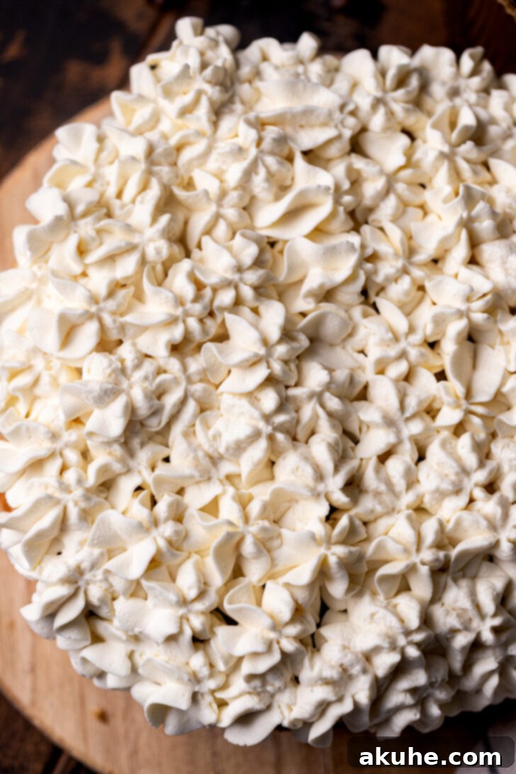 Piped mascarpone dollops on top of the cake.