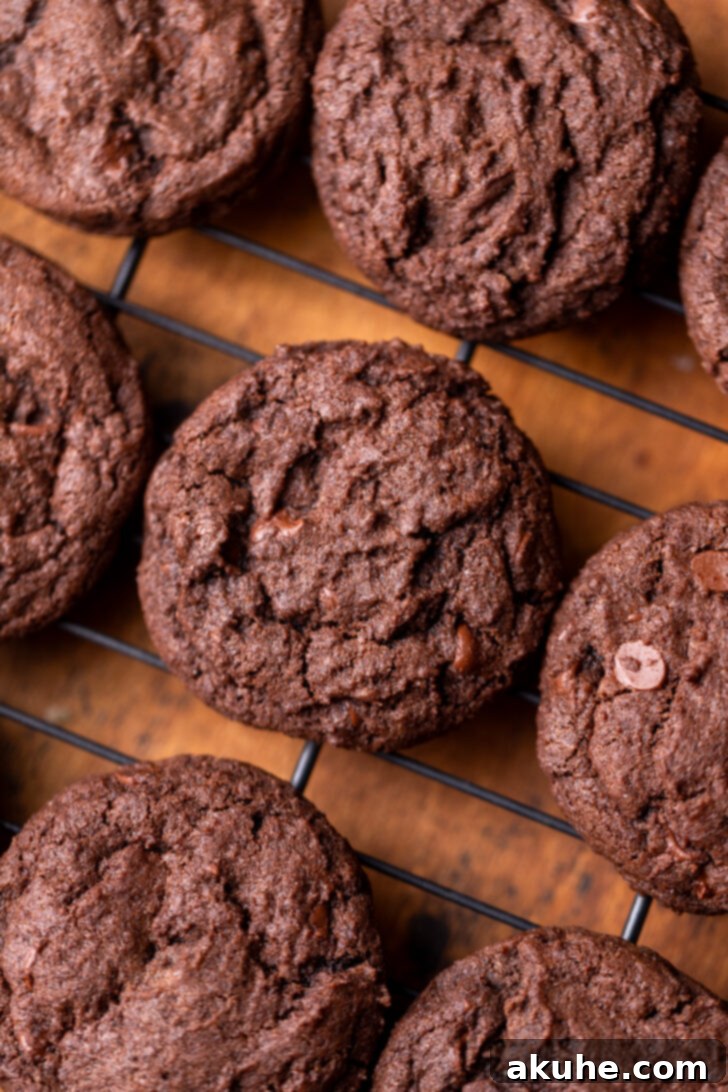 Cookie Dough Stuffed Cookies 7 Freshly baked chocolate cookies cooling on a wire rack after being removed from the oven.