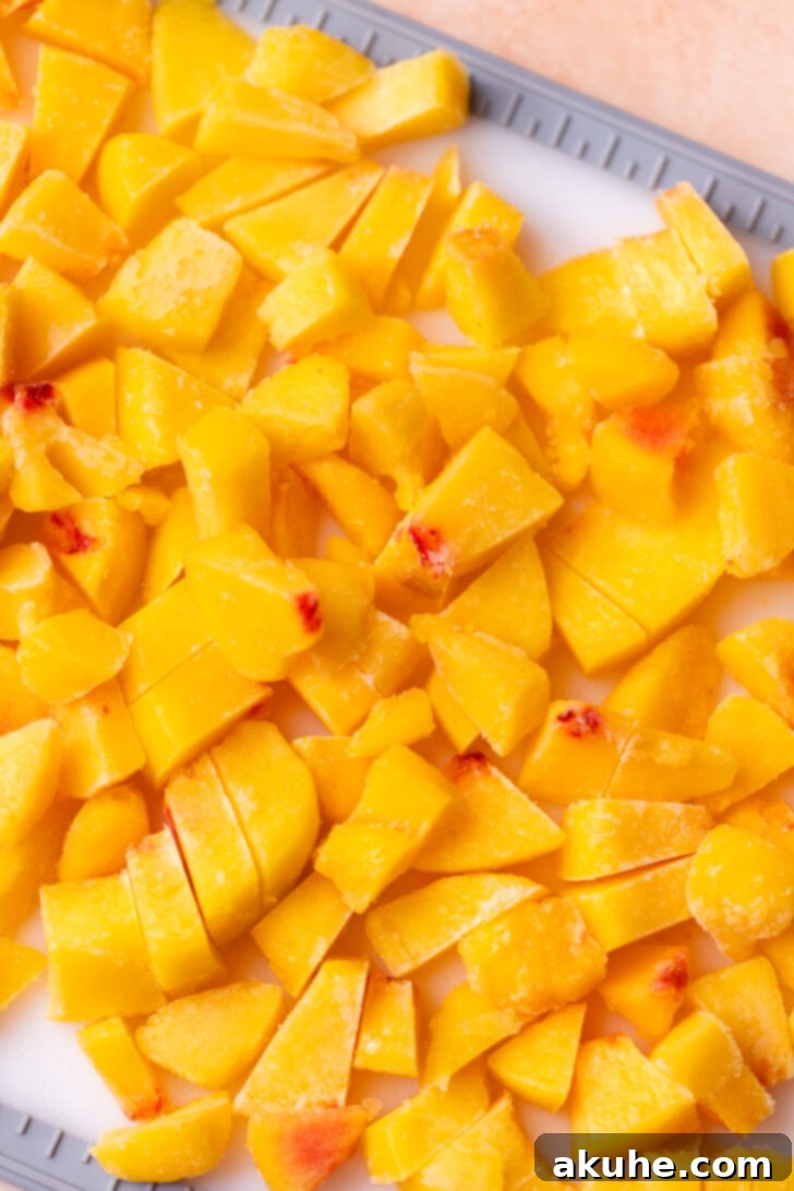 Classic Peach Pie Filling 4 Chopped peaches on a cutting board, ready for cooking.