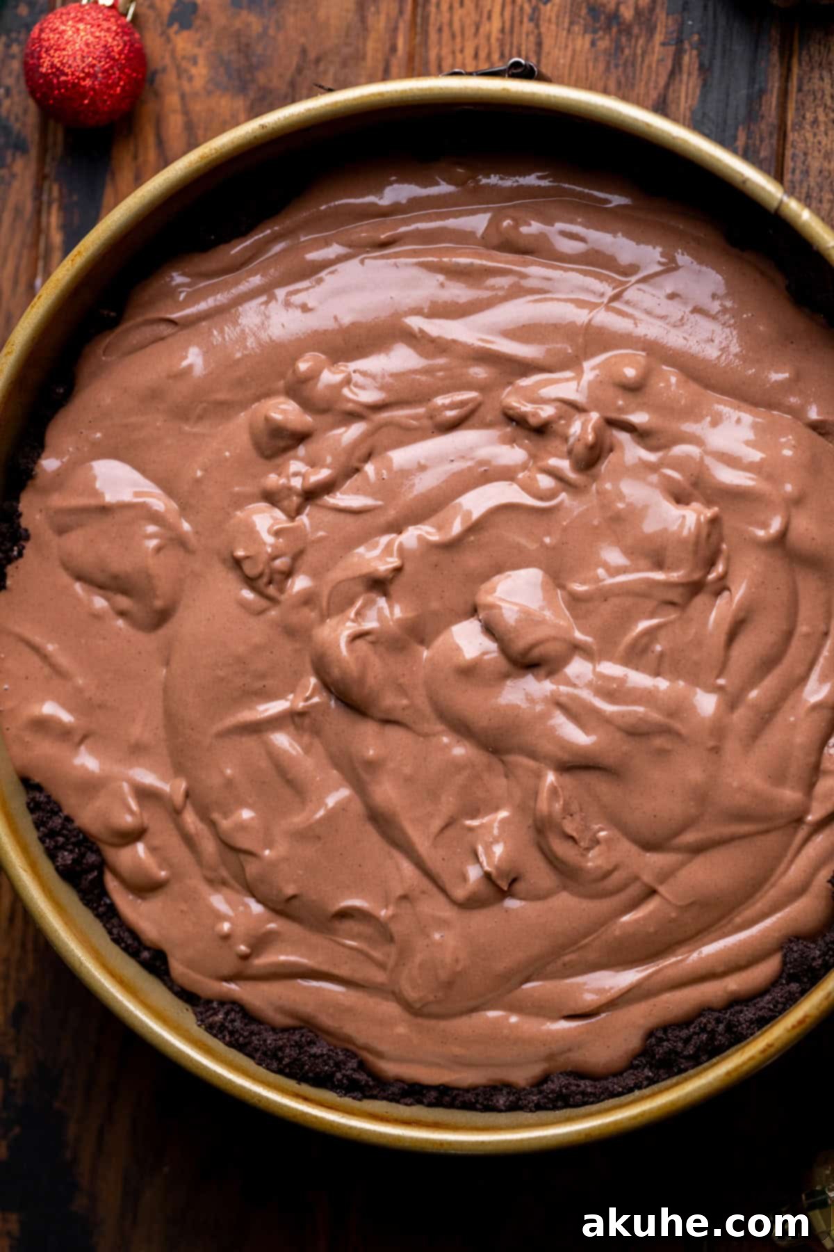 Decadent Hot Chocolate Cheesecake 6 Chocolate cheesecake batter neatly poured over the prepared Oreo crust in a springform pan.